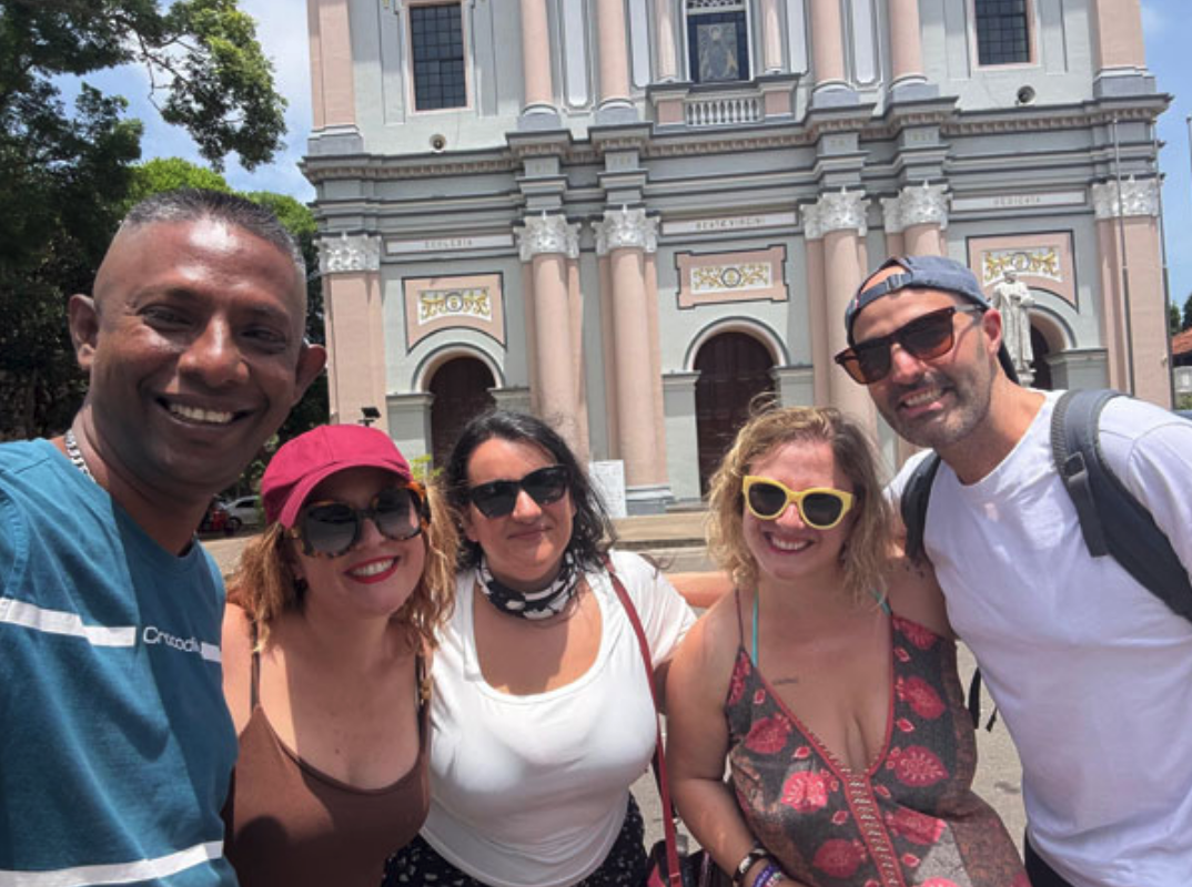 Group of travellers with their driver at a cultural stop in Sri Lanka