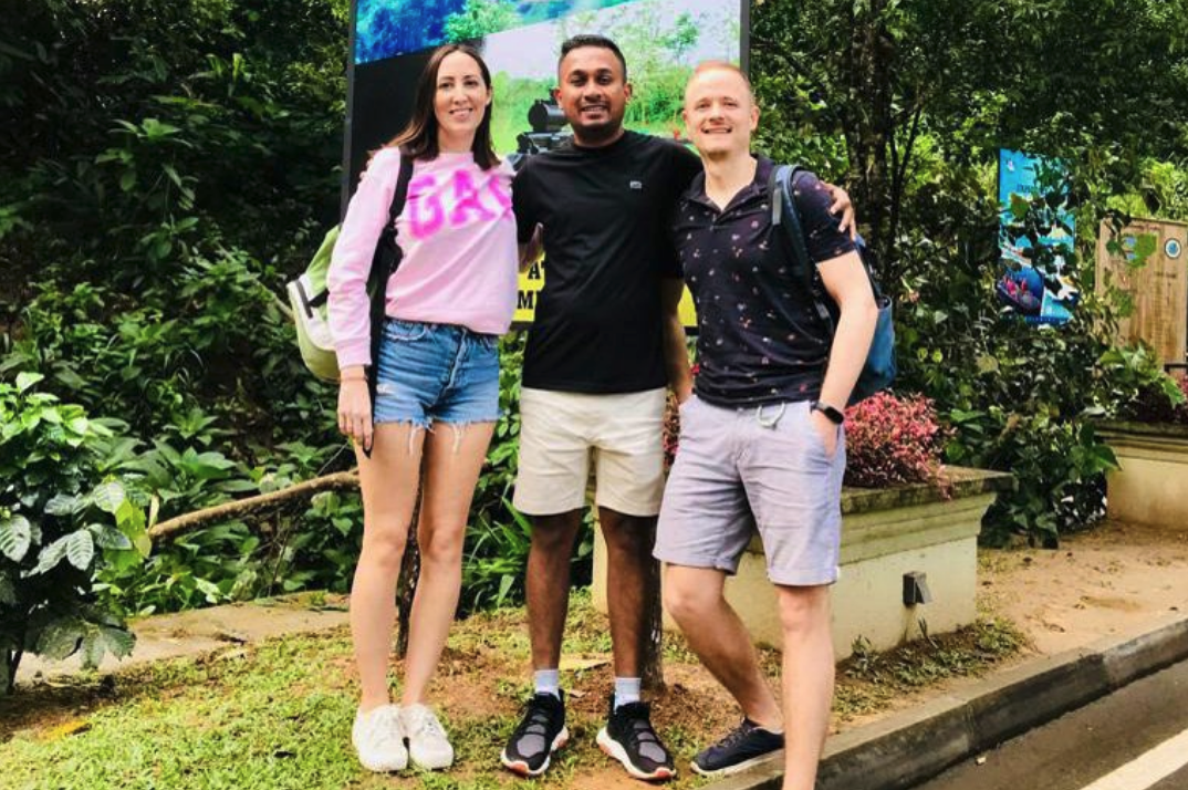Travellers with their driver during a garden sightseeing stop in Sri Lanka