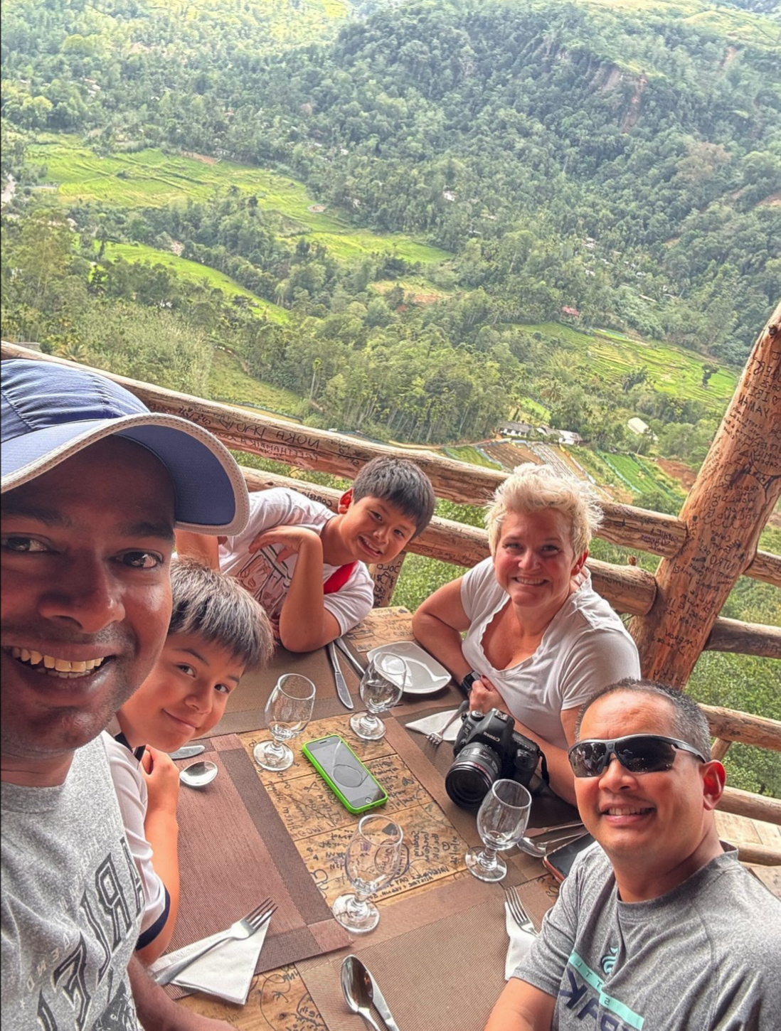 Family travellers and a private driver enjoying a hill country viewpoint in Sri Lanka