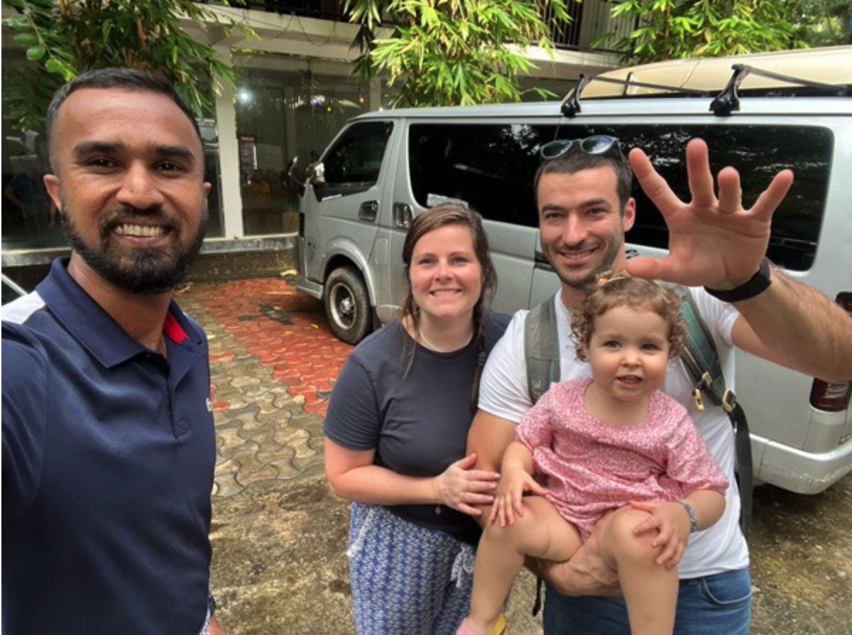 Travellers and their driver beside a private van in Sri Lanka